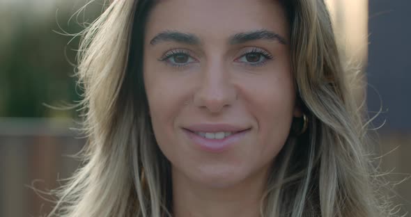 Close Up View of Happy Young Woman with Blond Hair Looking To Camera. Headshot of Pretty Female