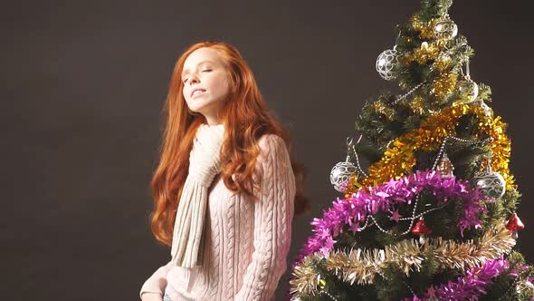 Redhead Smiling Girl Dancing in Christmas Party. Christmas Holiday Celebration.