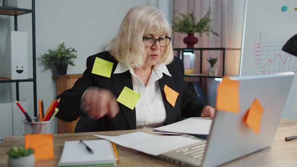 Tired Exhausted Senior Business Woman Office Manager with Laptop Sticky Notes Sticks with Many Tasks