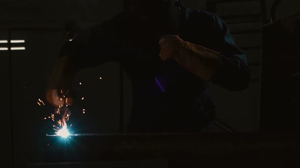 Metal Welder Working with Arc Welding Machine