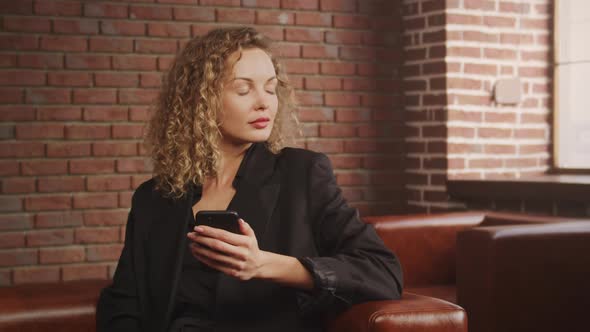 Caucasian Woman Hold Out to Think on Reply on Her Smart Phone