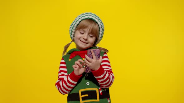 Kid Girl Christmas Elf Santa Helper Types Something on Mobile Phone Enjoys Browsing Social Media