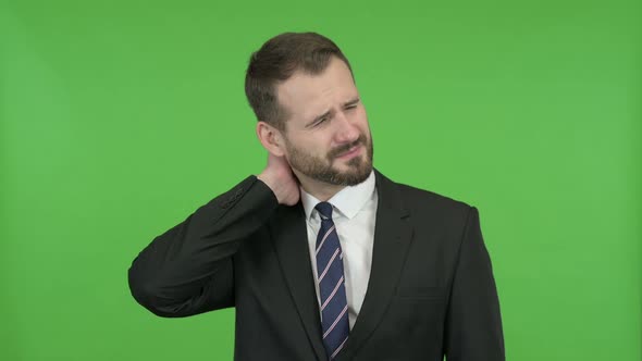 Tired Young Businessman Having Neck Pain Against Chroma Key