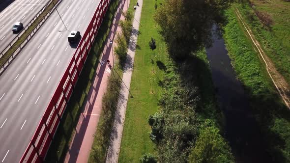 Aerial: the camera follows a bike on the highway, having fun and enjoying the road