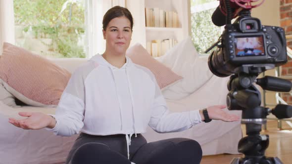 Caucasian blogger woman doing a video at home