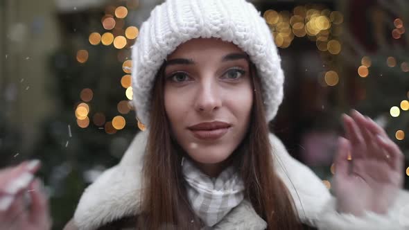 Smiling Girl Enjoying Snowfall on the Street