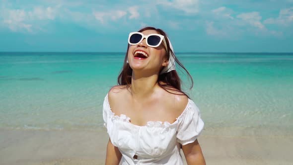 slow-motion of cheerful woman on the sea beach at Koh MunNork Island, Rayong, Thailand