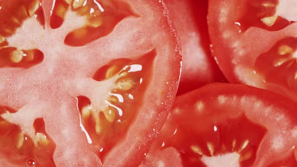 Slow Motion of Rotation Ripe Red Sliced Tomatoes