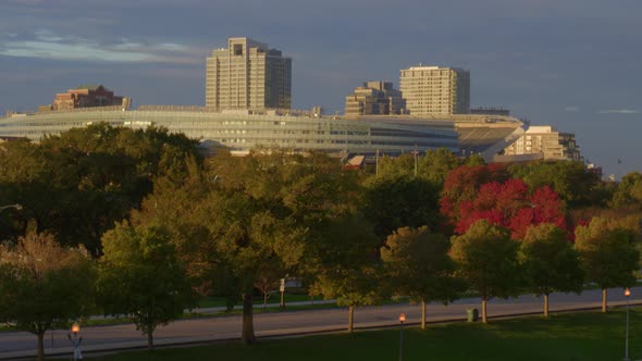 Aerial of autumn trees in front of Soldier field American football stadium