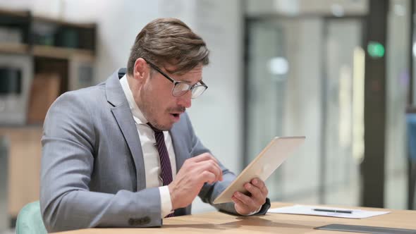 Disappointed Businessman Having Loss on Tablet in Office