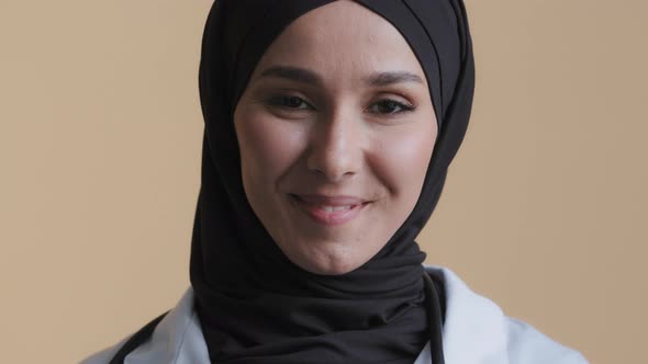 Smiling Muslim Arabian Female Doctor Surgeon in Hijab Traditional Headscarf Wear Medical Coat