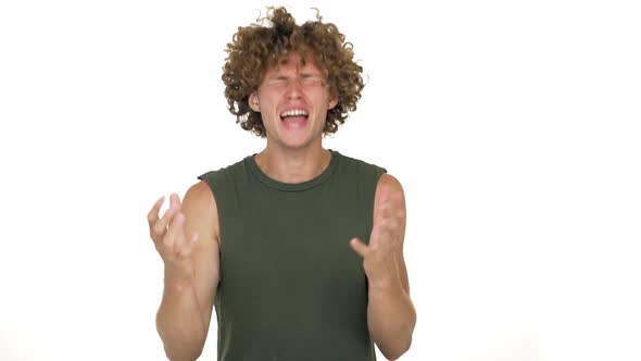 Fairhaired Curly Guy Isolated Over White Background Angrily Screaming on Camera with Incomprehension