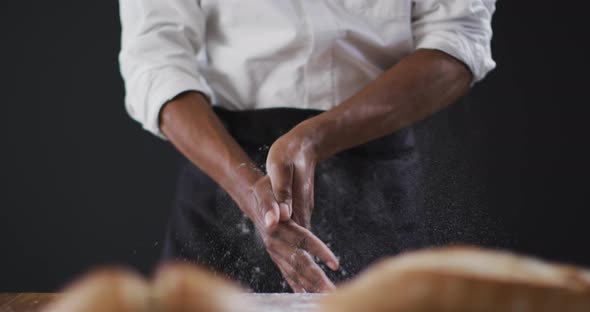 Video of cook throwing flour on the table on black background