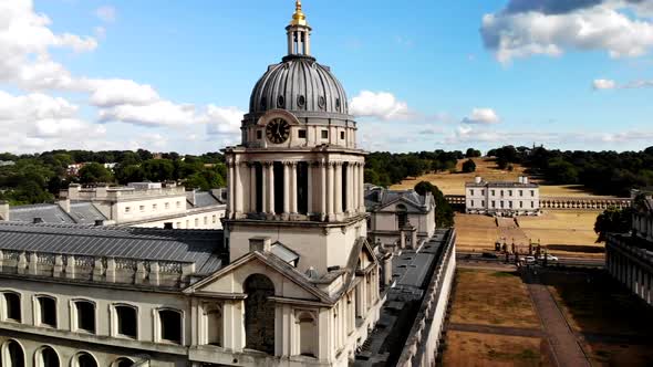 Drone footage of Old Royal Naval College in Greenwich, London City. Drone flies up and pans to the l