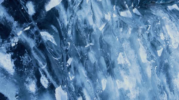 Closeup shot of the side of a glacier with melt water running down