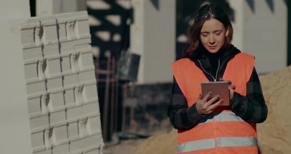 Construction Engineer Using Digital Tablet at Construction Site