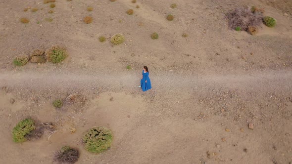 Woman in a Blue Dress in the Middle of a Landscape of Hardened Lava in the Teide National Park