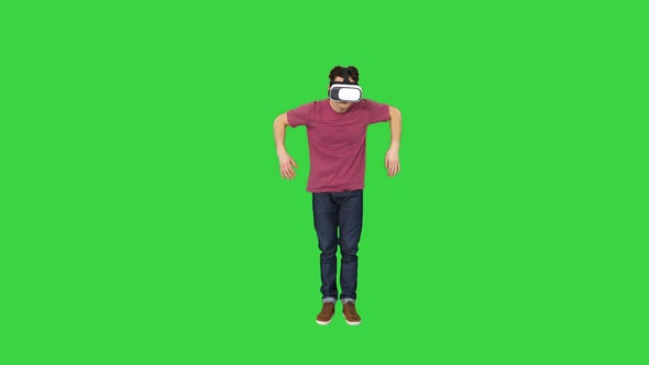 Casual Gamer Dancing Locking Hip-hop in VR Headset Playing Dancing Game on a Green Screen, Chroma