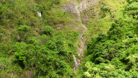 Cliff with a Waterfall in the Jungle. Cascade Waterfall on Luzon Island, Philippines