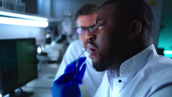 Black Scientist Discussing Cell Meat Patty with Colleague