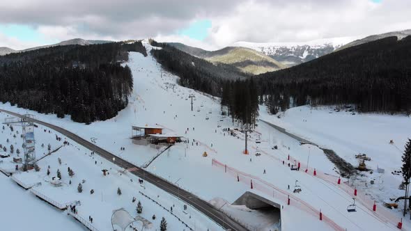 Aerial View on Ski Slopes with Skiers and Ski Lifts on Ski Resort in Winter