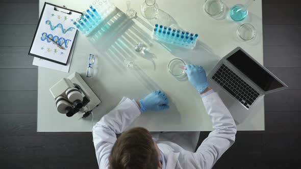 Laboratorian Combining Two Chemical Agents in Dish, Getting Discolored by Mixing