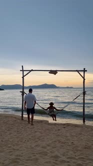 Men and Women Walking on the Beach Pattaya During Sunset in Thailand Ban Amphur Beach with Hammock