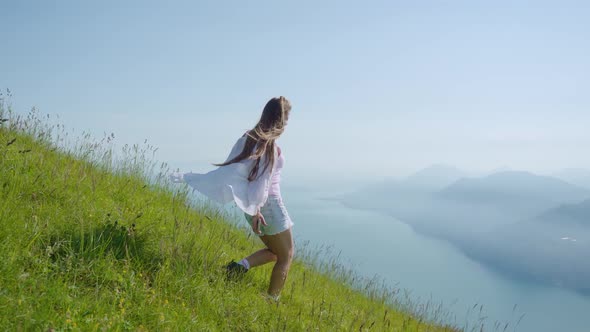 Girl Walks on the Grass with a Beautiful Panorama of Lake Garda