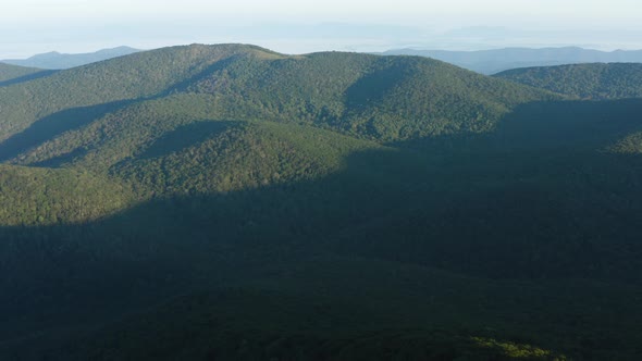 An aerial shot (dolly out) of Cole Mountain seen from the Mount Pleasant summit during a summer morn