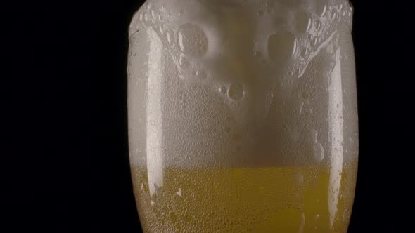 Beer Foam Pouring Over Cup Edge