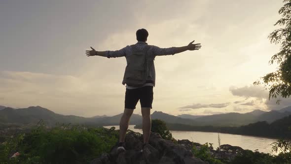 Young Man Celebrating On The Top Of Mountain