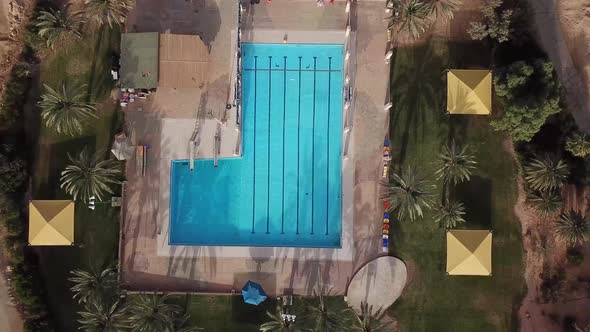 Drone view of a swimming pool in the middle of the desert. Yotvata village in Israel.