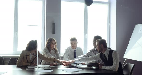 Office Workers Business People Fold Their Hands in Circle Celebrating Success of New Project