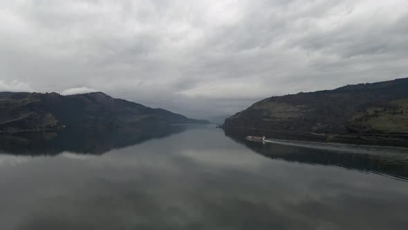 Dark storm clouds reflect off the mirror like waters of the Columbia River, aerial