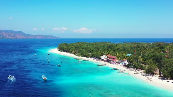 Beautiful aerial abstract shot of a paradise sunny white sand beach and blue sea background in 4K