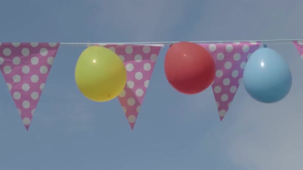 Balloons and bunting against blue sky