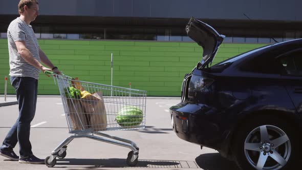 Guy with Foodstuffs Near Grocery Store