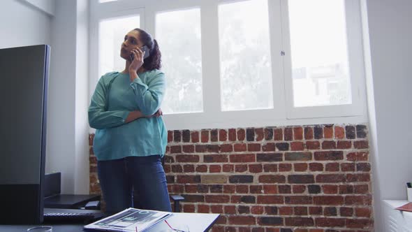 Woman talking on smartphone at office