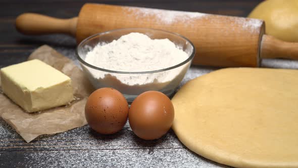 Rolled and Unbaked Shortcrust Pastry Dough Recipe on Wooden Background