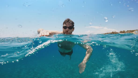 Young Boy is Swimming in the Open Ocean at Summer