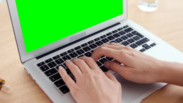 Businesswoman working over laptop at her desk