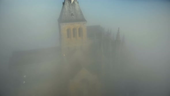 Atmospheric Aerial Close-up Shot of Mysterious Mont Saint Michel Island Fortress Abbey Under Thick