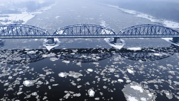 River with floe and snowy bridge, Bydgoszcz. Winter in Poland.