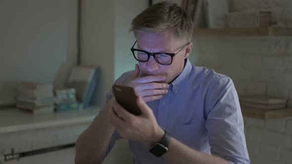 Businessman Having Headache While Using Smart Phone