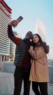 Loving Multiracial Couple Taking Self Portrait in City