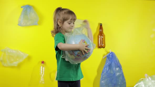 Girl Activist Tries To Free Earth Globe From Plastic Package. Reduce Trash Pollution. Save Ecology