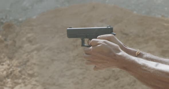 Pistol shooting bullets in slow motion footage. Hand guns in firing range