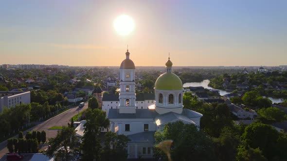 Small Church at the Bright Cloudy Sunset Filmed By Drone in Small European City, Kyiv Region