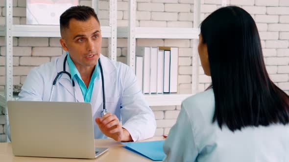 Doctor in Professional Uniform Examining Patient at Hospital