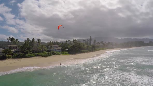 Aerial view of a man kitesurfing in Hawaii